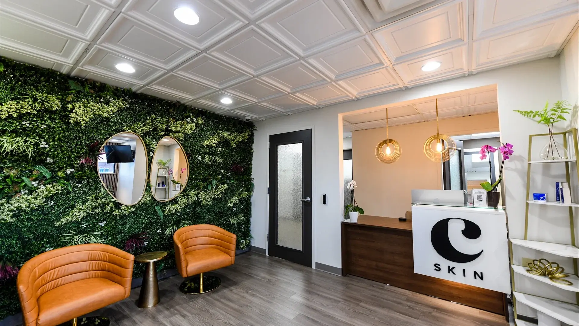 The Choosi lobby, living green wall with two leather chairs and the c SKIN reception desk beyond